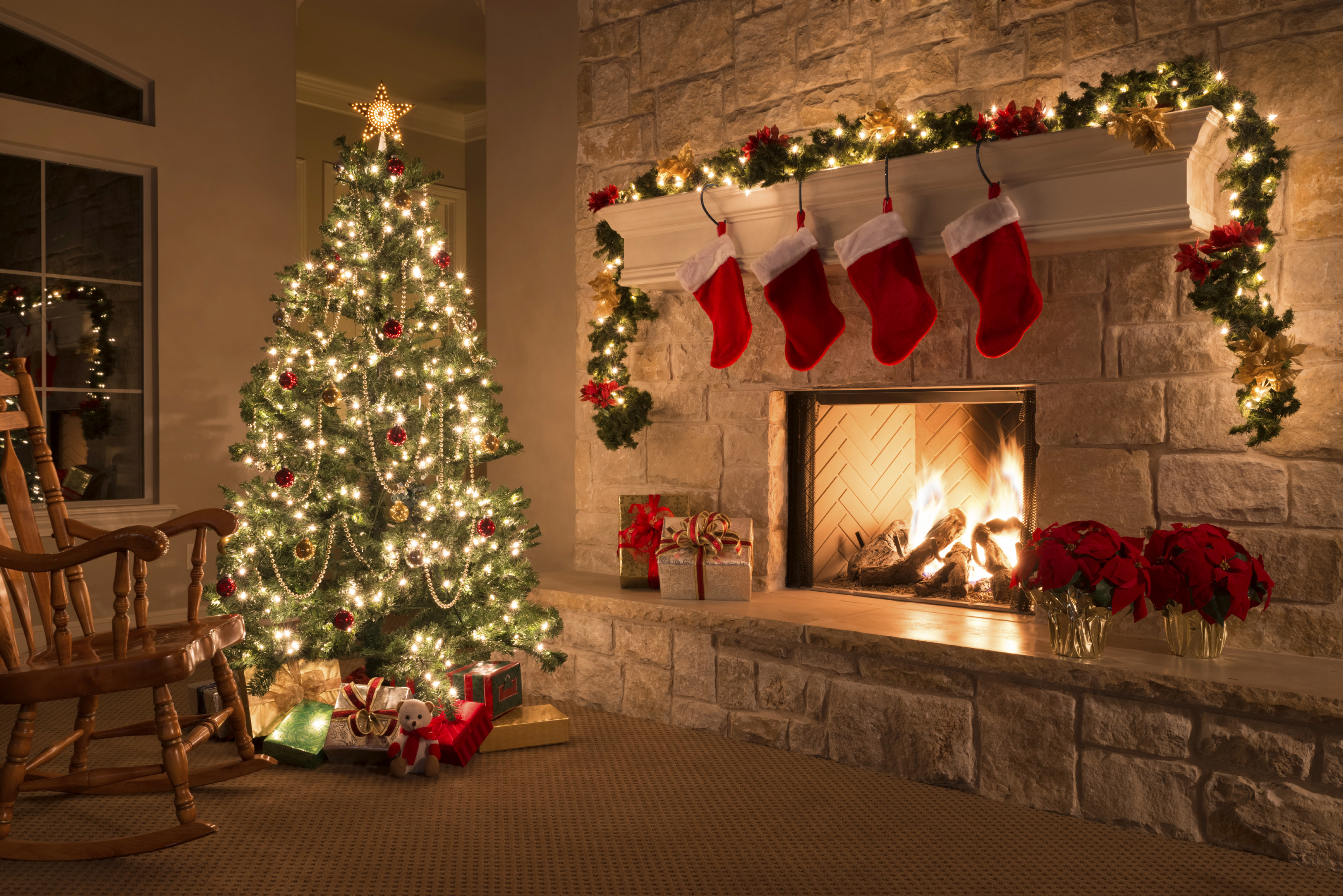 room with christmas tree decorations and stockings