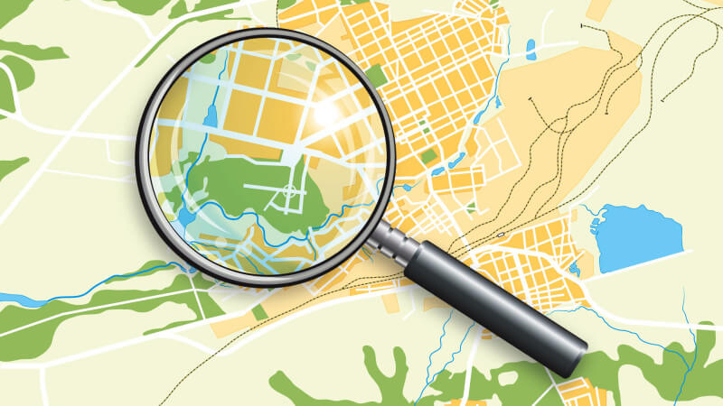magnifying glass on map graphic