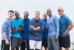 group of men laughing in blue shirts