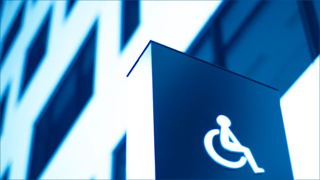ADA compliance wheelchair symbol on building